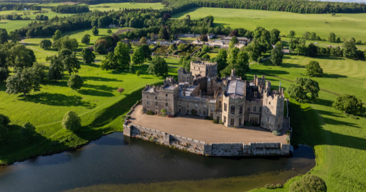 Aerial view of Raby Castle, Park and Gardens, showing lush green parkland and historic castle at centre.